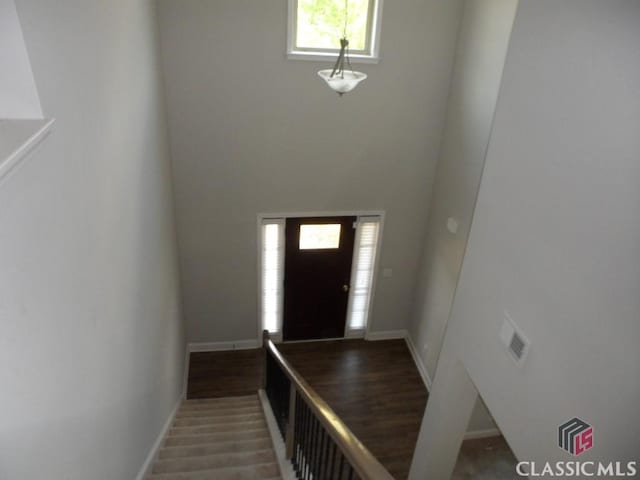 628 Holliman Cir, Pendergrass, GA 30567 - entrance foyer featuring baseboards, a high ceiling, and wood finished floors