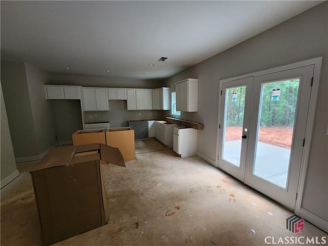 350 Discovery Trl, Athens, GA 30605 - kitchen featuring french doors, white cabinets, concrete floors, and a sink