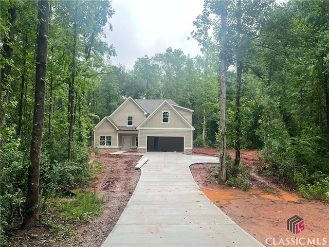 375 Discovery Trl, Athens, GA 30605 - view of front of house featuring driveway, a wooded view, board and batten siding, and a garage