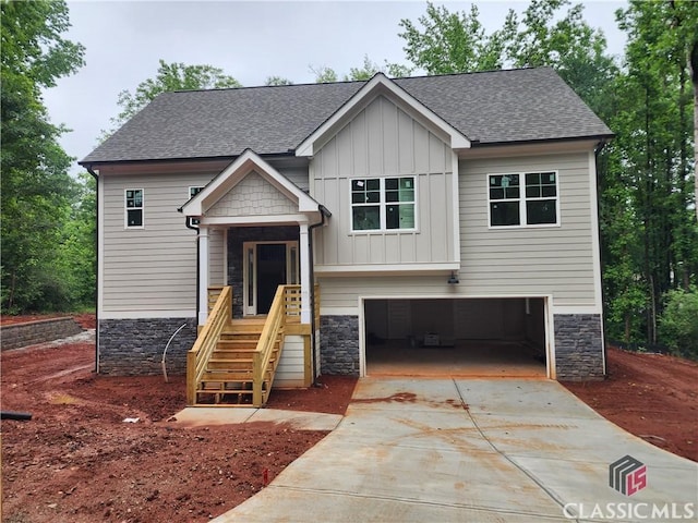 355 Discovery Trl, Athens, GA 30605 - view of front of home featuring board and batten siding, a garage, driveway, and roof with shingles