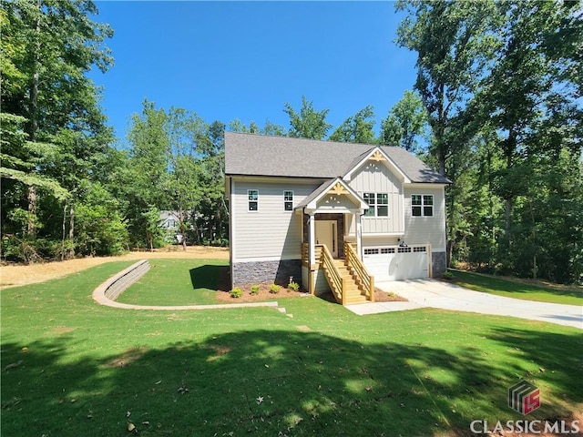 355 Discovery Trl, Athens, GA 30605 - craftsman-style home featuring an attached garage, concrete driveway, board and batten siding, a front yard, and stone siding