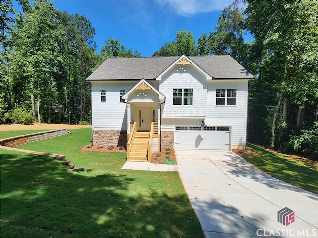 365 Discovery Trl, Athens, GA 30605 - view of front of house featuring an attached garage, concrete driveway, a front yard, roof with shingles, and stone siding