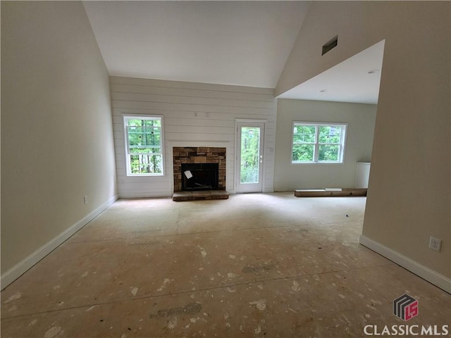 365 Discovery Trl, Athens, GA 30605 - unfurnished living room with healthy amount of natural light, baseboards, a stone fireplace, and high vaulted ceiling
