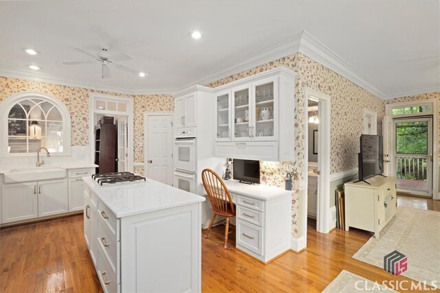 416 Mcdaniel St, Monroe, GA 30655 - kitchen featuring wallpapered walls, a sink, crown molding, stainless steel gas stovetop, and ceiling fan