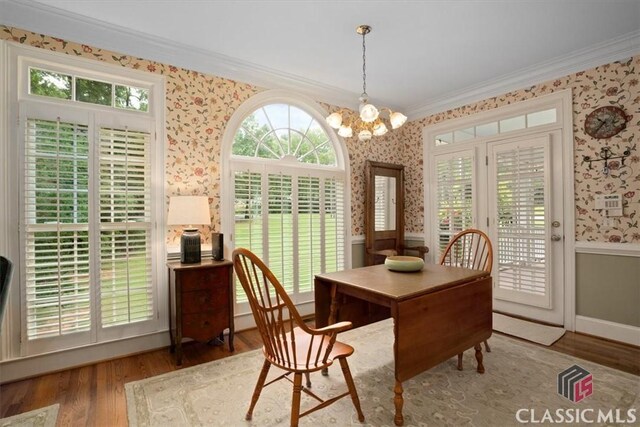 416 Mcdaniel St, Monroe, GA 30655 - dining room with wallpapered walls, ornamental molding, wood finished floors, plenty of natural light, and a chandelier