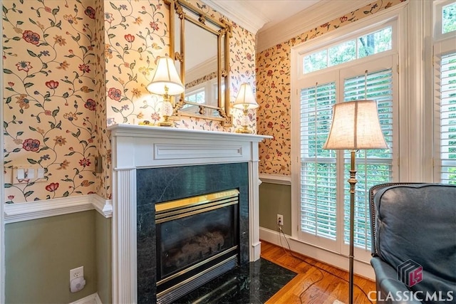 416 Mcdaniel St, Monroe, GA 30655 - detailed view of wallpapered walls, crown molding, a high end fireplace, wood finished floors, and baseboards