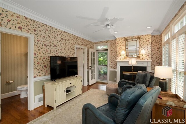 416 Mcdaniel St, Monroe, GA 30655 - living room featuring wallpapered walls, ornamental molding, wood finished floors, a fireplace, and ceiling fan