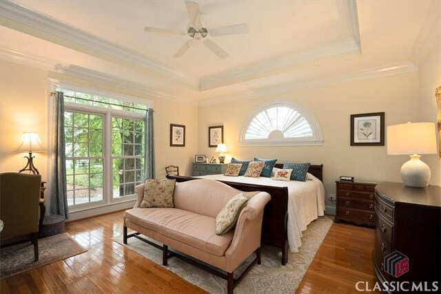 416 Mcdaniel St, Monroe, GA 30655 - bedroom featuring multiple windows, wood-type flooring, a raised ceiling, ornamental molding, and a ceiling fan