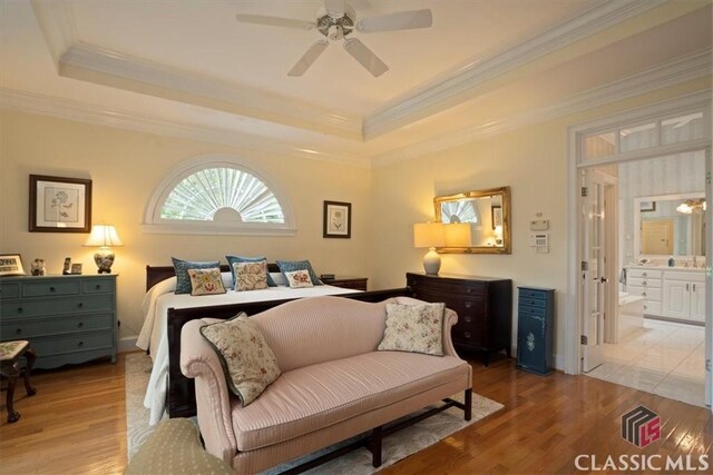 416 Mcdaniel St, Monroe, GA 30655 - bedroom with light wood-style flooring, crown molding, a raised ceiling, ensuite bathroom, and ceiling fan