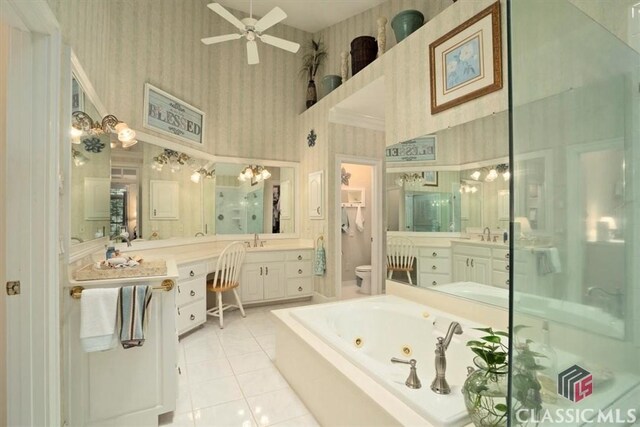 416 Mcdaniel St, Monroe, GA 30655 - full bathroom with wallpapered walls, a whirlpool tub, ceiling fan, vanity, and toilet