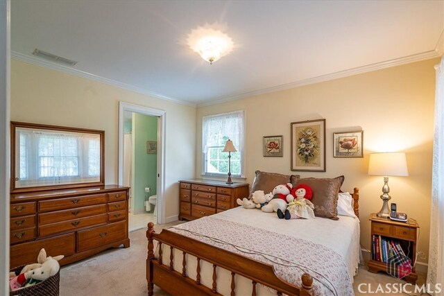 416 Mcdaniel St, Monroe, GA 30655 - bedroom featuring light colored carpet, ornamental molding, ensuite bathroom, and baseboards