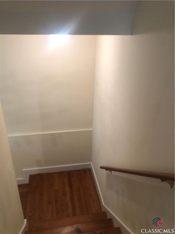 416 Mcdaniel St, Monroe, GA 30655 - staircase with wood finished floors and baseboards