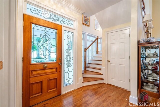 416 Mcdaniel St, Monroe, GA 30655 - entrance foyer featuring wood finished floors, stairs, baseboards, and vaulted ceiling