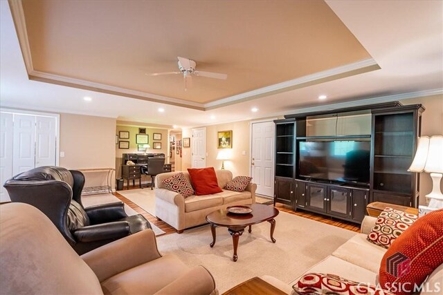 416 Mcdaniel St, Monroe, GA 30655 - living area with a raised ceiling, crown molding, wood finished floors, ceiling fan, and recessed lighting