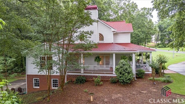 416 Mcdaniel St, Monroe, GA 30655 - view of front facade featuring covered porch, a chimney, roof with shingles, and brick siding