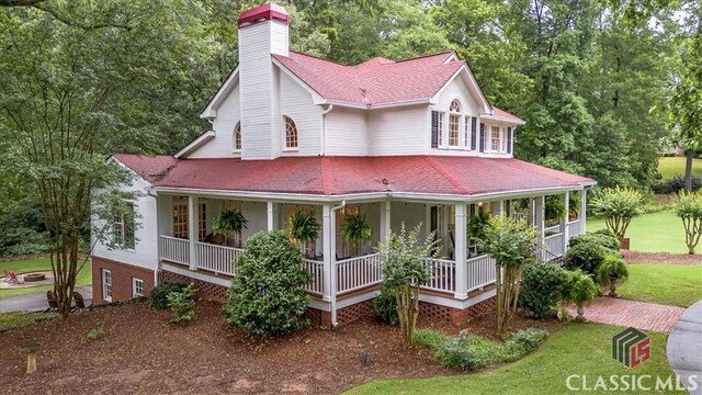 416 Mcdaniel St, Monroe, GA 30655 - farmhouse inspired home featuring a chimney, a porch, roof with shingles, and a front yard
