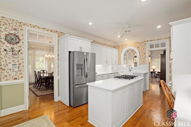 416 Mcdaniel St, Monroe, GA 30655 - kitchen with stainless steel fridge, wallpapered walls, crown molding, light countertops, and a ceiling fan