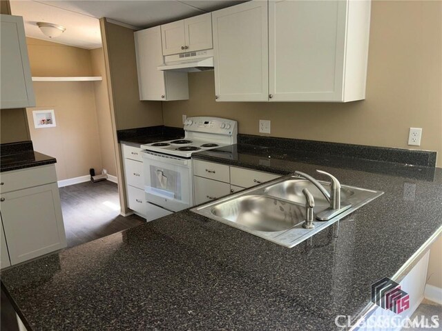 117 Lombardy Dr, Athens, GA 30601 - kitchen featuring white electric range, a sink, white cabinets, under cabinet range hood, and dark wood-style flooring