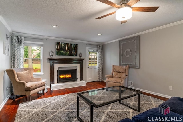 4080 Derby, Cumming, GA 30040 - living area featuring crown molding, plenty of natural light, wood finished floors, a fireplace, and a textured ceiling