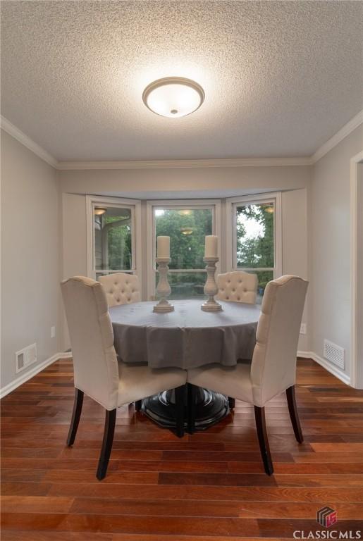 4080 Derby, Cumming, GA 30040 - dining space with a textured ceiling, wood finished floors, crown molding, and baseboards