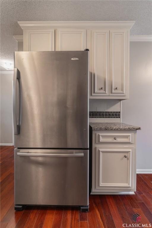 4080 Derby, Cumming, GA 30040 - kitchen featuring freestanding refrigerator, crown molding, light stone counters, dark wood finished floors, and white cabinetry