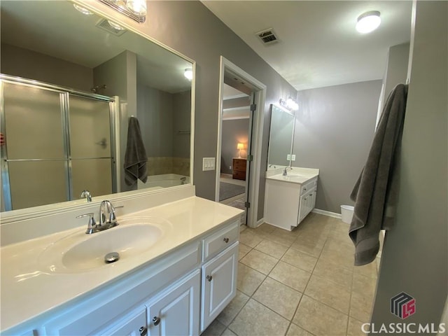 1100 Roberta Dr, Bishop, GA 30621 - bathroom featuring vanity, a garden tub, tile patterned floors, a stall shower, and baseboards