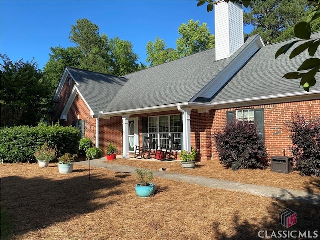 1100 Roberta Dr, Bishop, GA 30621 - view of front of home featuring brick siding, a shingled roof, and a chimney