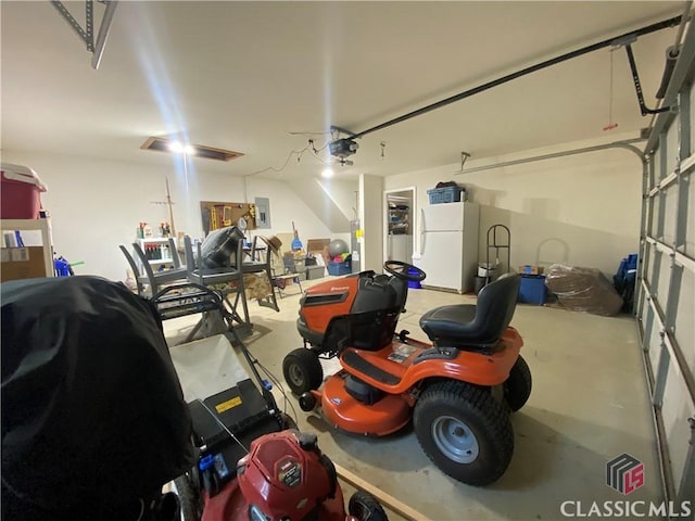 1100 Roberta Dr, Bishop, GA 30621 - garage with freestanding refrigerator, a garage door opener, and electric panel