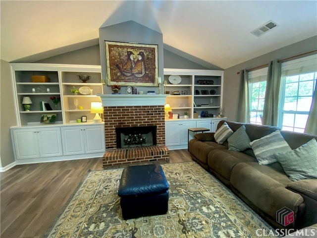 1100 Roberta Dr, Bishop, GA 30621 - living room with lofted ceiling, wood finished floors, and a brick fireplace