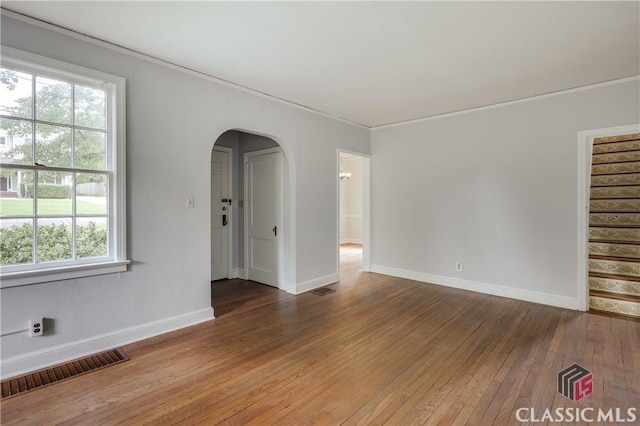 170 Stanton, Athens, GA 30606 - empty room featuring hardwood / wood-style flooring, arched walkways, baseboards, stairway, and crown molding