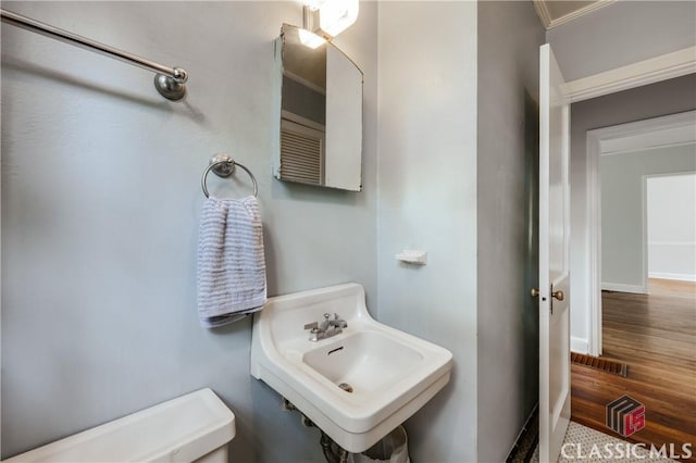 170 Stanton, Athens, GA 30606 - half bathroom with crown molding, wood finished floors, toilet, a sink, and baseboards