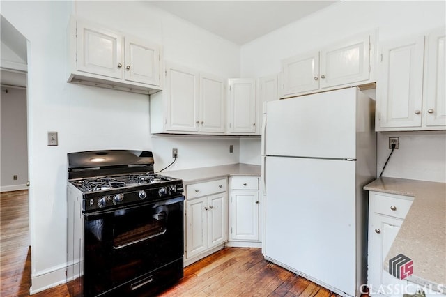 170 Stanton, Athens, GA 30606 - kitchen featuring freestanding refrigerator, black range with gas cooktop, light countertops, and wood finished floors