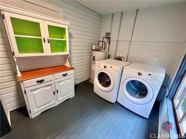 180 N Poplar St, Athens, GA 30601 - laundry area with cabinet space, electric water heater, independent washer and dryer, dark wood finished floors, and wood walls