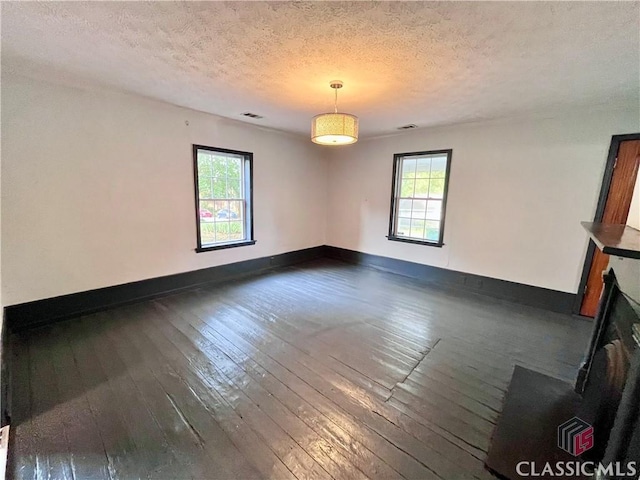 180 N Poplar St, Athens, GA 30601 - unfurnished room with dark wood-style flooring, a textured ceiling, and baseboards