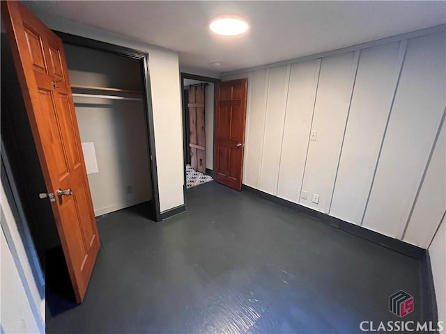 180 N Poplar St, Athens, GA 30601 - unfurnished bedroom with finished concrete floors and baseboards
