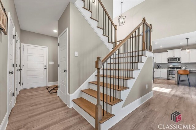 1810 Willow Creek Dr, Watkinsville, GA 30677 - staircase featuring wood finished floors, recessed lighting, and baseboards