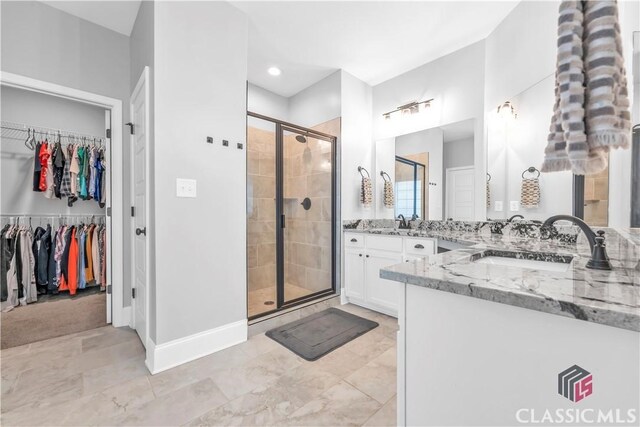 1810 Willow Creek Dr, Watkinsville, GA 30677 - bathroom with a stall shower, vanity, a spacious closet, and baseboards