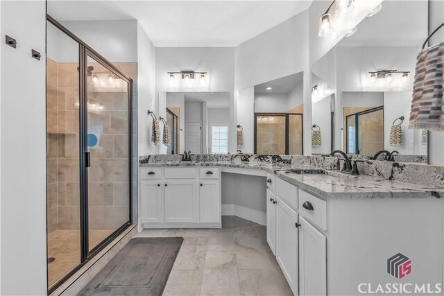 1810 Willow Creek Dr, Watkinsville, GA 30677 - bathroom featuring a shower stall, vanity, and marble look tiles