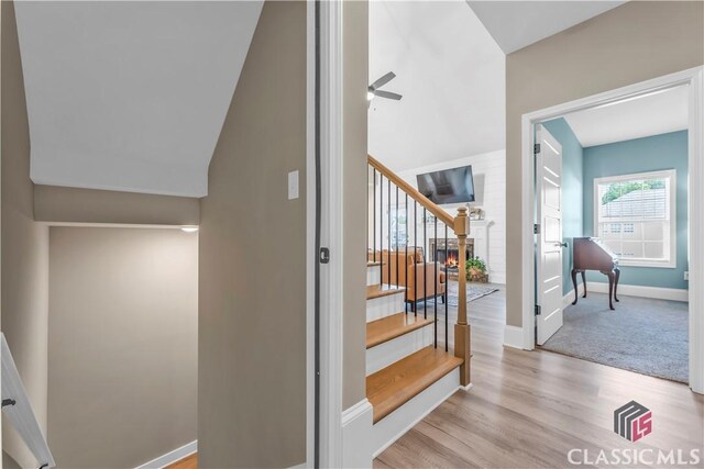 1810 Willow Creek Dr, Watkinsville, GA 30677 - staircase featuring wood finished floors, a ceiling fan, baseboards, and lofted ceiling