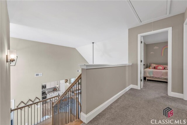 1810 Willow Creek Dr, Watkinsville, GA 30677 - hallway with attic access, an upstairs landing, baseboards, light carpet, and vaulted ceiling
