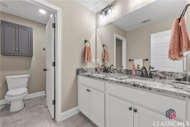 1810 Willow Creek Dr, Watkinsville, GA 30677 - full bathroom featuring baseboards, double vanity, marble finish flooring, and toilet