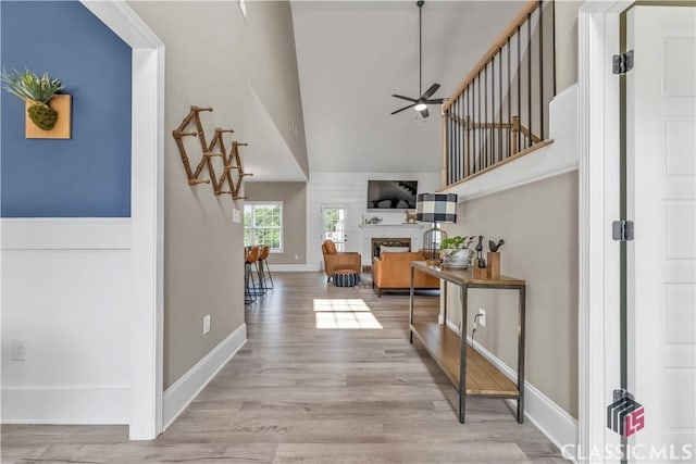 1810 Willow Creek Dr, Watkinsville, GA 30677 - foyer with a ceiling fan, a towering ceiling, a fireplace, baseboards, and wood finished floors