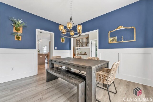 1810 Willow Creek Dr, Watkinsville, GA 30677 - dining area featuring a wainscoted wall, a chandelier, a decorative wall, and wood finished floors