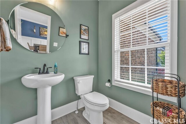 1810 Willow Creek Dr, Watkinsville, GA 30677 - bathroom with toilet, wood finished floors, and baseboards