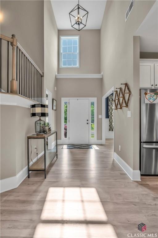 1810 Willow Creek Dr, Watkinsville, GA 30677 - foyer with a high ceiling, light wood-style flooring, plenty of natural light, and baseboards