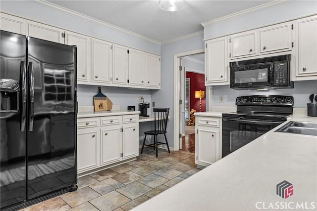 161 Pinecrest Ter, Athens, GA 30606 - kitchen with black appliances, light countertops, crown molding, stone finish floors, and white cabinetry