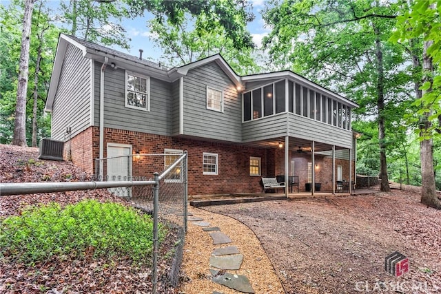 161 Pinecrest Ter, Athens, GA 30606 - rear view of house with brick siding, a patio, an attached garage, a sunroom, and a ceiling fan