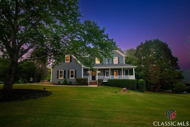 1851 Harvest Way, Loganville, GA 30052 - view of front facade featuring a porch and a lawn