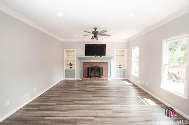 1851 Harvest Way, Loganville, GA 30052 - unfurnished living room featuring wood finished floors, a brick fireplace, baseboards, crown molding, and recessed lighting