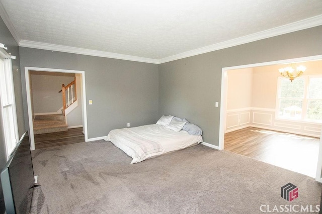 1851 Harvest Way, Loganville, GA 30052 - unfurnished bedroom with a chandelier, carpet flooring, ornamental molding, and baseboards